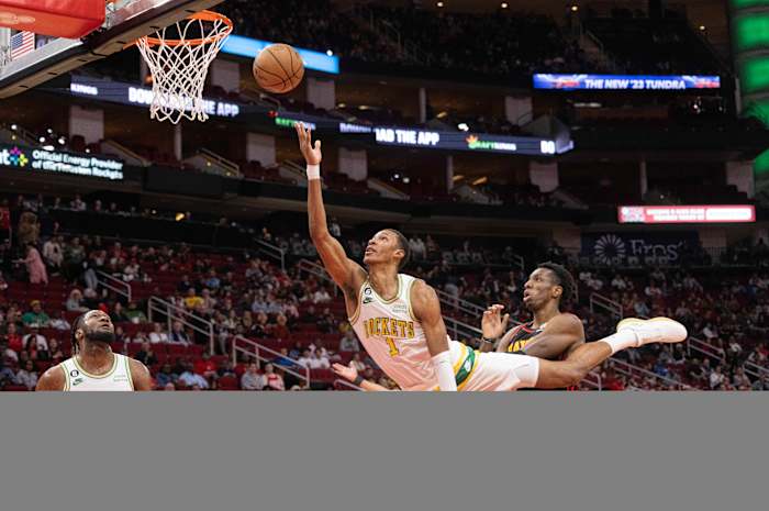Rockets forward Jabari Smith Jr. is fouled by Atlanta Hawks forward De'Andre Hunter in the first quarter at Toyota Center.